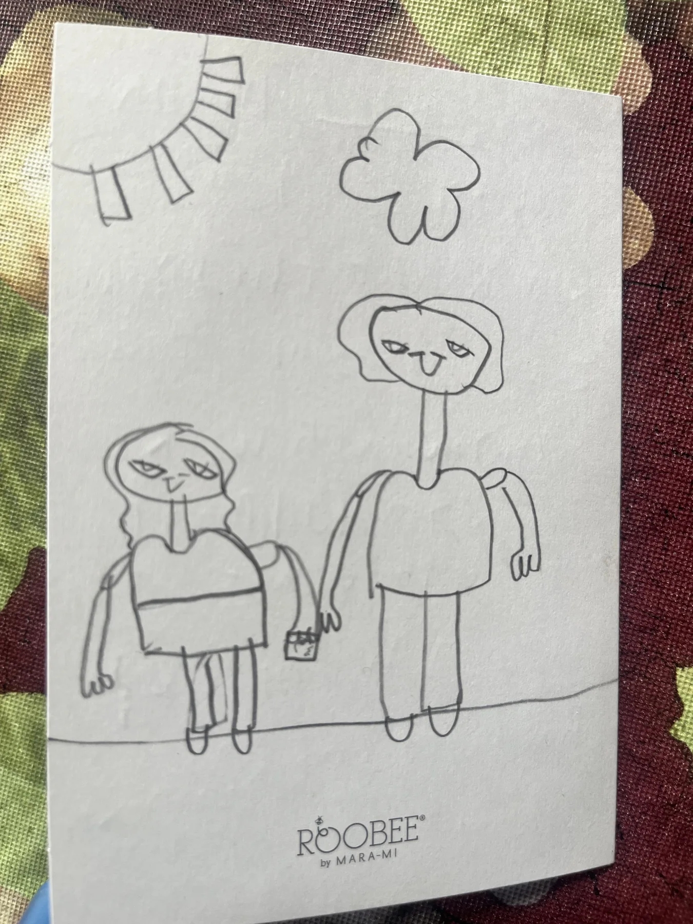 A child’s drawing of a student standing beside their ROW reader