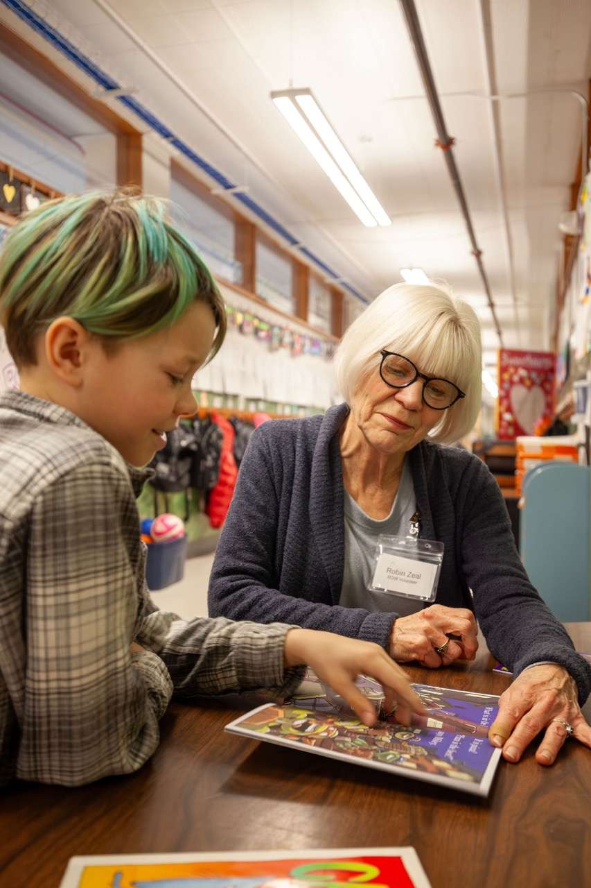 ROW readers and volunteers learning together around a table
