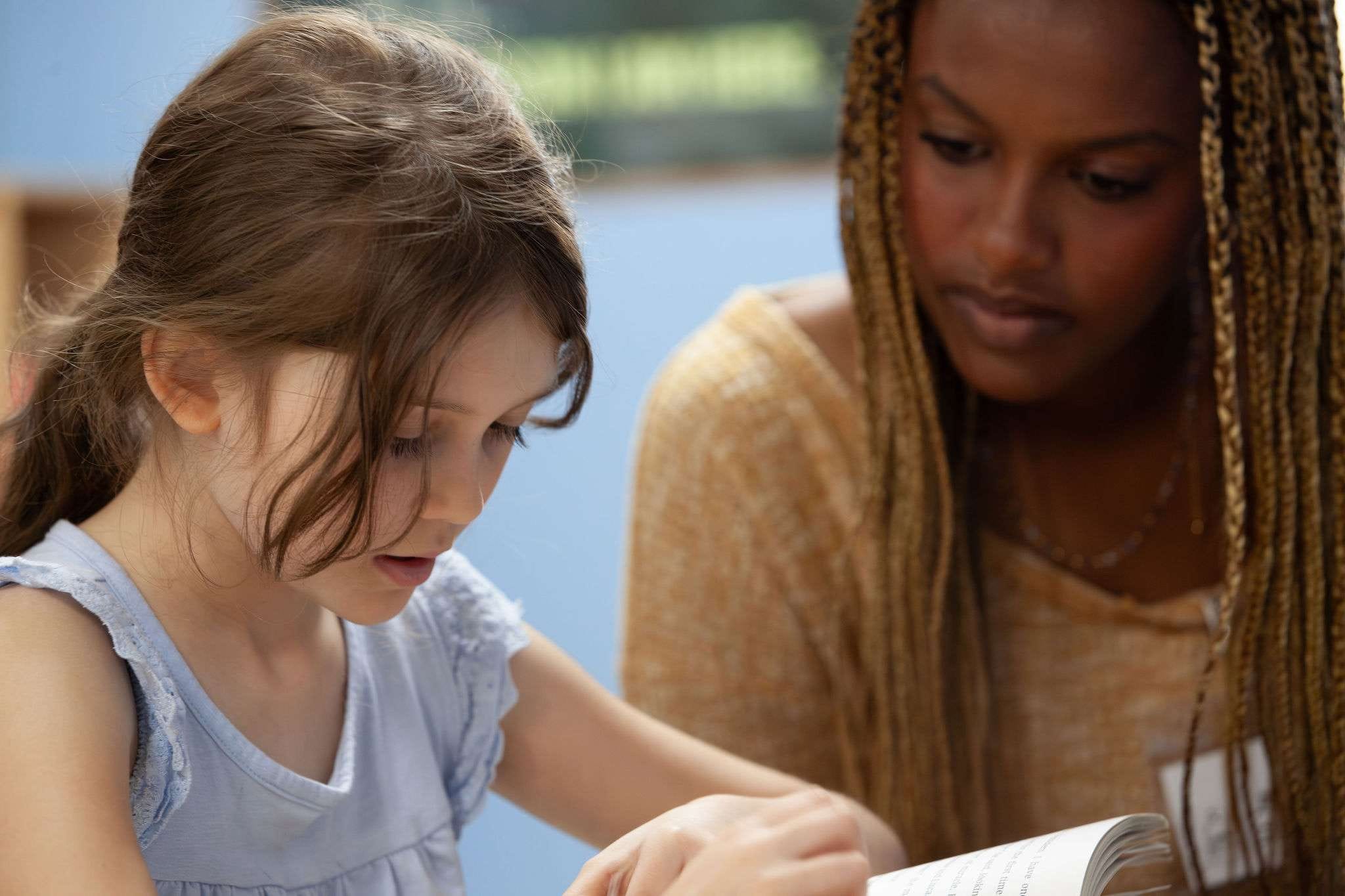 A ROW volunteer and student reading together